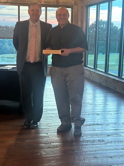 Mr. Stover awarding Mr. Conkle with Holmes Middle School Teacher of the Year award.