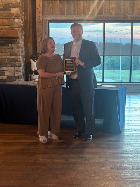 Dr. Stover awarding Mrs. Huss with the RCS CTE Teacher of the Year.