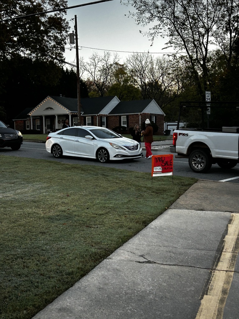 Lady in car pool line stopping cars asking if they'd like to purchase donuts