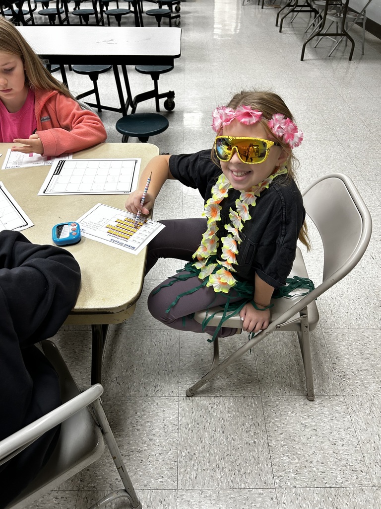 Student wears floral crown and necklace with sunglasses