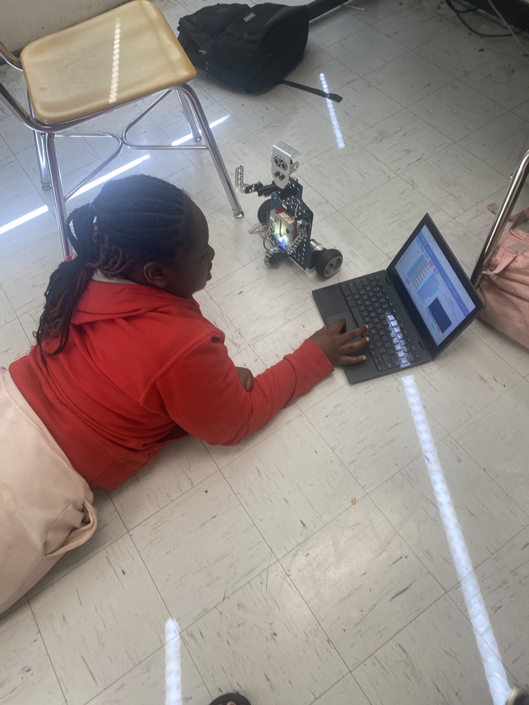 Students working with robots in computer science discoveries class