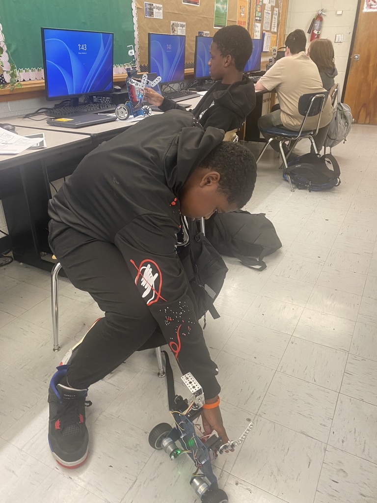 Students working with robots in computer science discoveries class