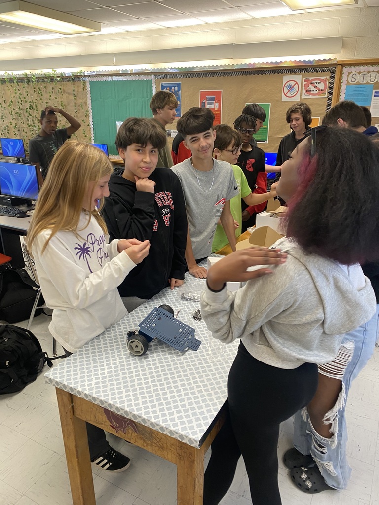 Students working with robots in computer science discoveries class