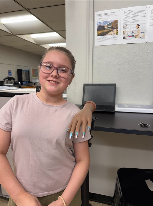 student showing off a nail design in cosmetology & barbering