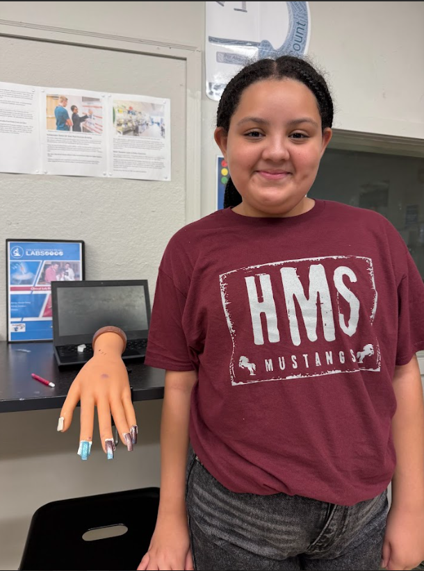 student showing off a nail design in cosmetology & barbering