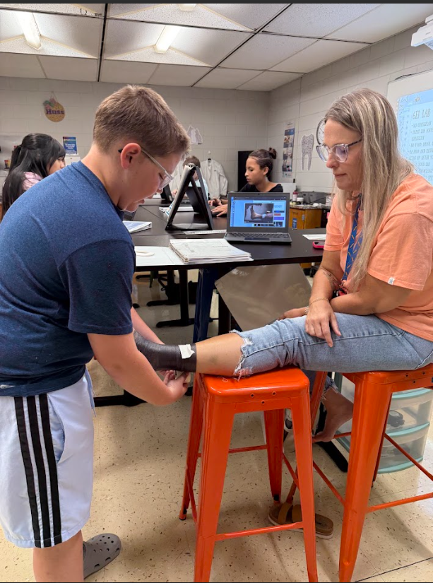 Mrs. Grogan getting her ankle wrapped in sports medicine