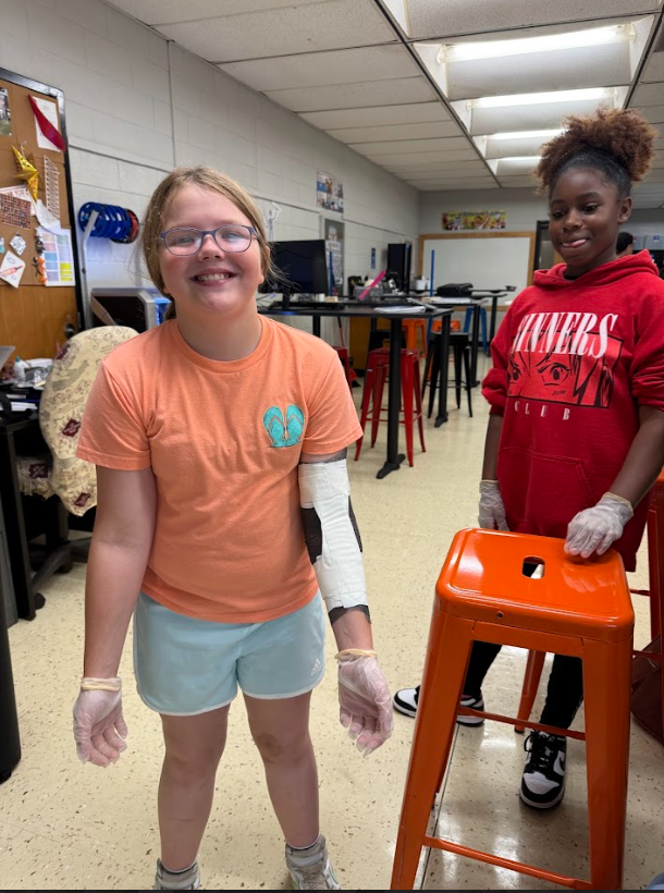 student with an elbow wrapped in sports medicine