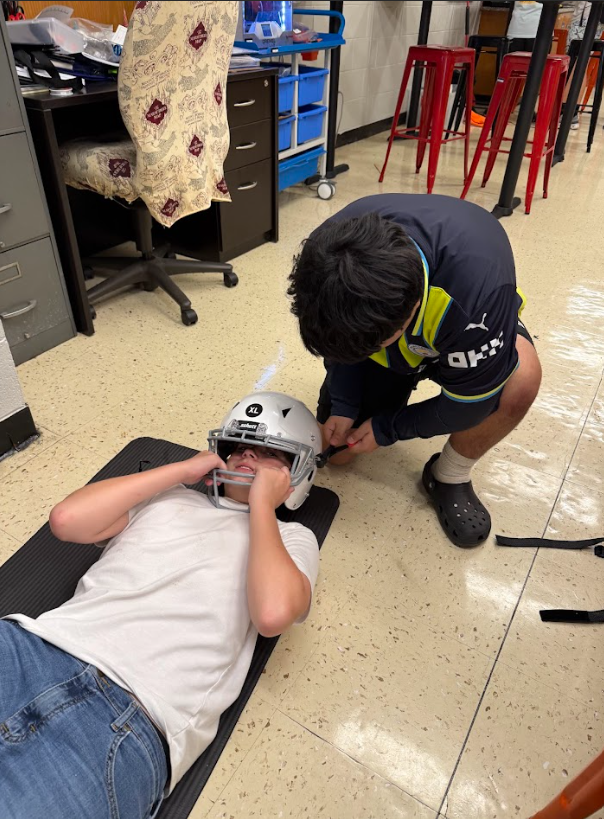 removing a football facemask with angel cutters in sports medicine