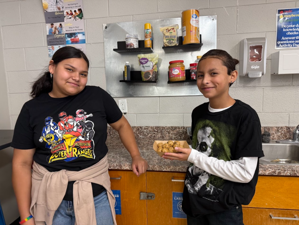 Students showing off no bake energy bites in Intro to Culinary Arts