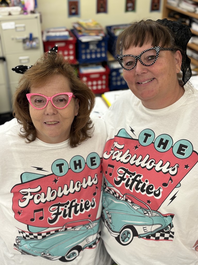 Mrs. Owen and Mrs. Dishmon wearing matching 50's day shirts and glasses.