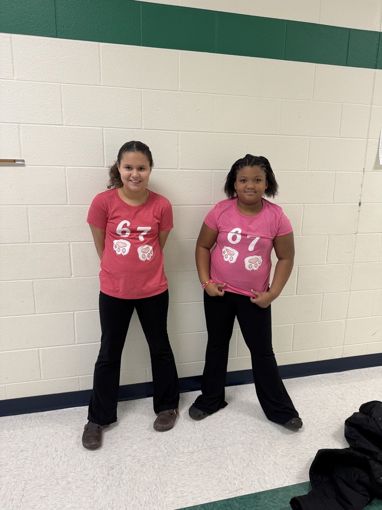 Two 5th grade girls wearing 6 7 shirts for twin day.