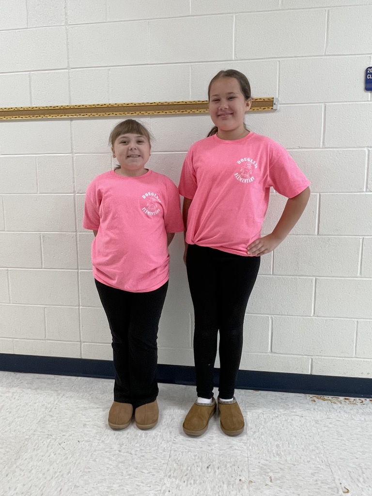 Two third grade girls wearing pink shirts, black plans, and ugg slippers for twin day!