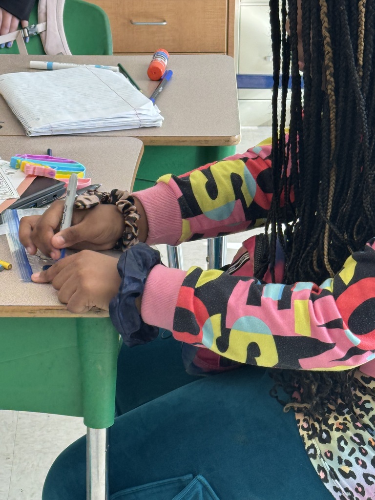 A student working on her water cycle model bag.
