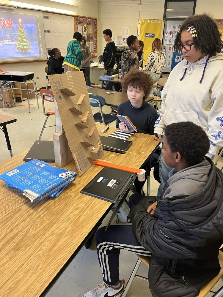 students making Rube Goldberg machines