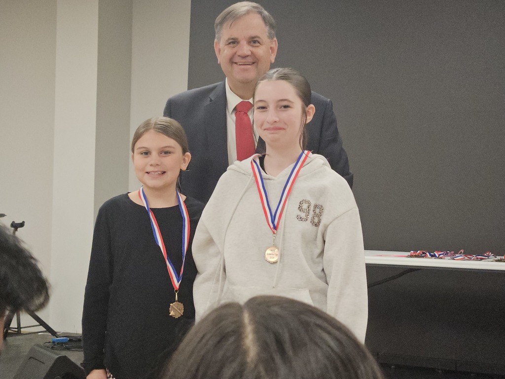 students with superintendent at district science fair