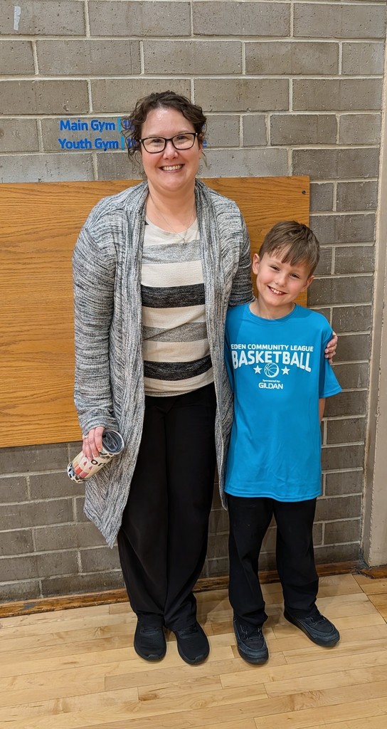 Mrs. Hinson with one forth grader at his basketball game.