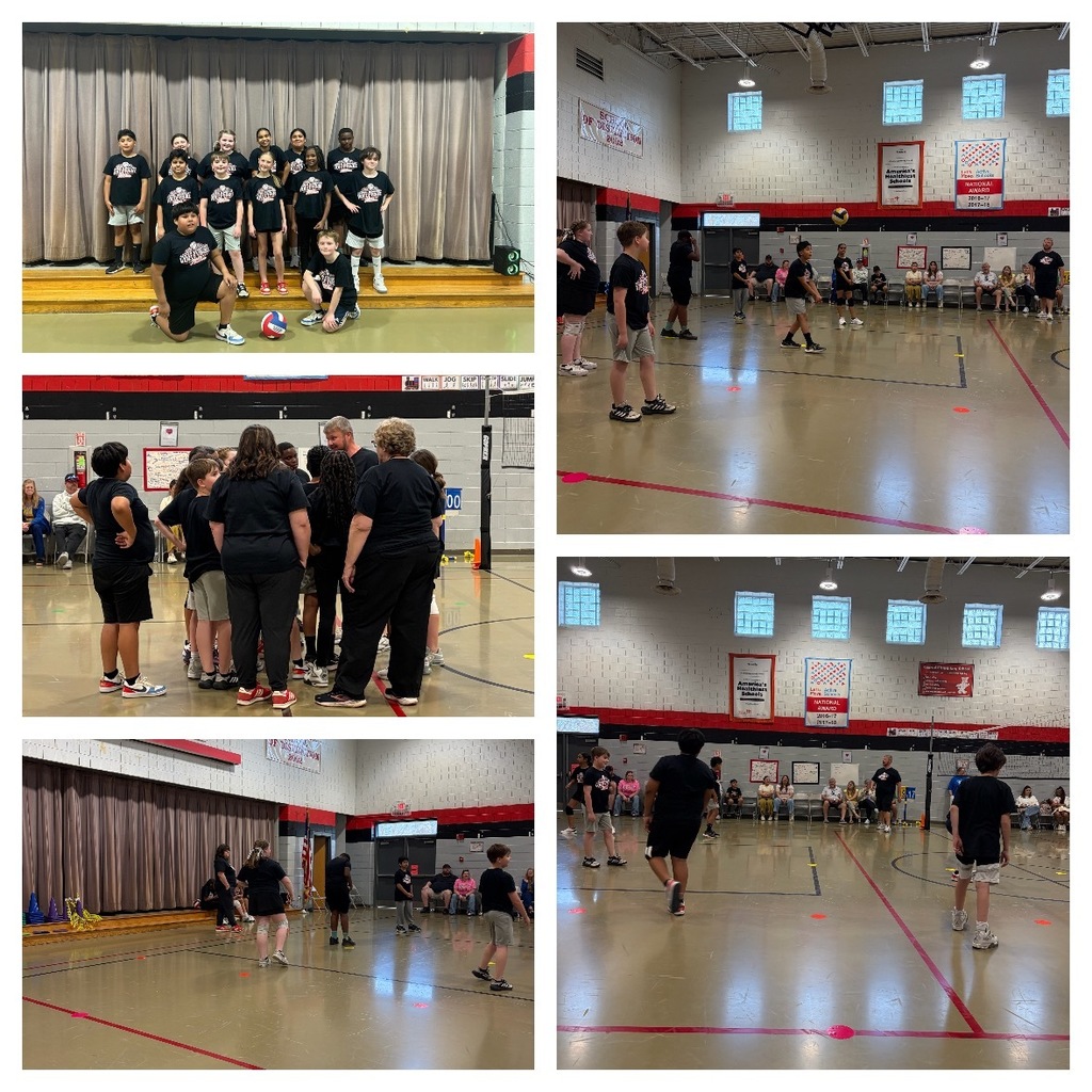 Alt Text: A five-photograph collage documents a youth volleyball event at a school or community center gymnasium.  Top Left: Approximately 16 children and young adults dressed in black t-shirts with white designs pose on a low stage against a dark curtain backdrop. Two children kneel in the front, with one holding a volleyball, and partial text "SPORTS" is visible on one child's shirt.  Top Right: An action shot shows children playing volleyball on a court with a net visible in the middle. Several adults are seated along the far wall observing the game.  Middle Left: A huddle of children and several adults, including two coaches, gather on the volleyball court, apparently receiving instructions or discussing strategy.  Bottom Left: Children engage in volleyball practice or play on the court while an adult observes from the left side of the frame.  Bottom Right: Another action shot from a different perspective shows children playing volleyball in the gymnasium with spectators seated along the wall in the background.  Gymnasium banners and signage visible throughout the photos display text including "ON DECK OR OVER THE TOP," "AmeriCorps' Talent," "WE ARE NATIONAL," "NATIONAL VOLLEYBALL," and "WE ARE CHAMPIONS." 