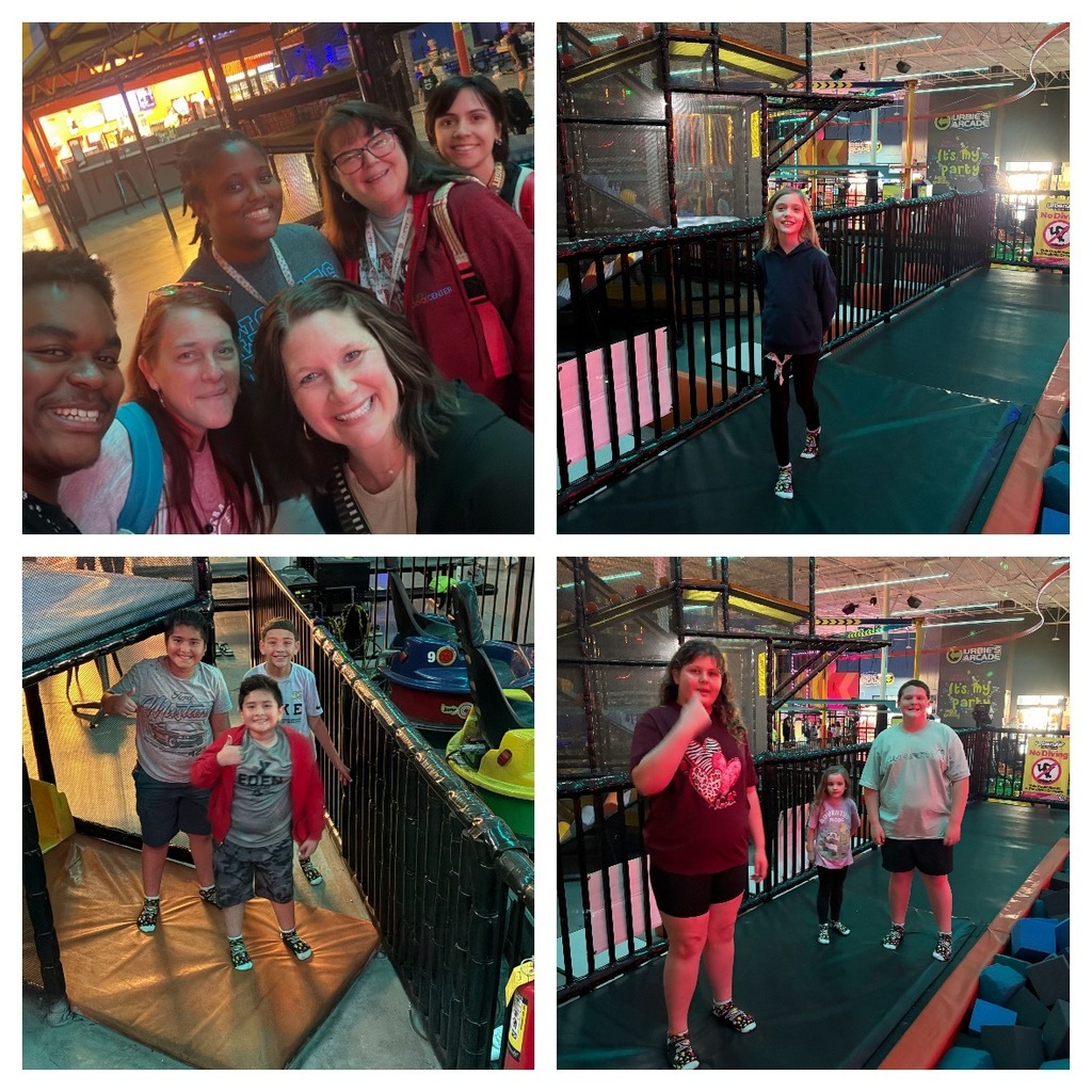 Alt Text: A four-photograph collage captures adults and children enjoying various activities at an indoor entertainment center featuring arcade games, obstacle courses, and play structures. Top Left: A group of six adults—three men and three women—smile and pose together for a selfie indoors. Bright lights and entertainment venue structures are visible in the background. Top Right: A young girl with blonde hair wearing a dark blue hoodie and black leggings smiles while walking on a padded pathway. The pathway is part of an indoor obstacle course or play structure with black railings and netting. Signs for "URBIE'S ARCADE," "It's my party," and a "No DIVE" safety sign (featuring a person diving with a red circle and line through it) are visible in the background, along with a stylized "R" venue logo. Bottom Left: Three boys stand on a padded platform giving thumbs-up gestures next to small, colorful ride-on vehicles resembling bumper boats or children's rides—one red vehicle numbered 9 and one yellow vehicle. Their shirts display partial text including "Mustang," "KE," and "EDEN." Bottom Right: Two girls and one boy stand on a padded surface with black railings, netting, and large blue foam blocks visible in the background, indicating a foam pit area. Signs for "URBIE'S ARCADE" and "It's my party" are visible in the background, along with the venue's stylized "R" logo and a "No DIVE" safety sign. Overall Setting: The indoor entertainment center features padded pathways, obstacle courses, black safety railings and netting, foam pit areas with blue foam blocks, arcade zones, party areas, and ride-on vehicle attractions, creating a comprehensive family entertainment facility.