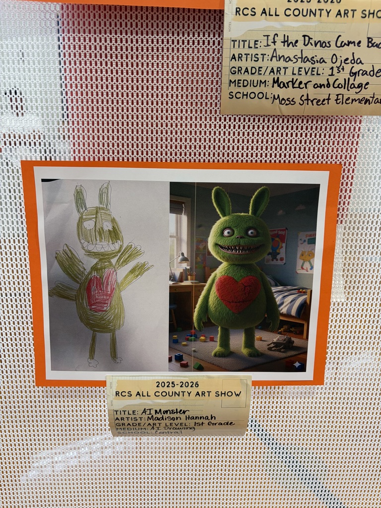 Alt Text: Two artworks are displayed side-by-side as part of the 2025-2026 RCS All County Art Show.  Left Artwork: "If the Dinos Came Back" by Anastasia Ojeda, 1st Grade, Moss Street Elementary. Created with marker and collage, this child's drawing depicts a green, bunny-like monster with large eyes, prominent teeth, and a red heart on its chest, rendered in green marker with red crayon accents.  Right Artwork: "AI Monster" by Madison Hannah, 1st Grade, Central Elementary School. Created using AI drawing technology, this photorealistic image shows the same green, bunny-like monster with large eyes, prominent teeth, and a red heart on its chest standing in a child's bedroom. The AI-generated monster has a fuzzy, three-dimensional texture and is surrounded by scattered toys on the floor and a bed visible in the background.  The side-by-side comparison showcases the contrast between traditional child-created artwork and AI-generated imagery of the same subject.