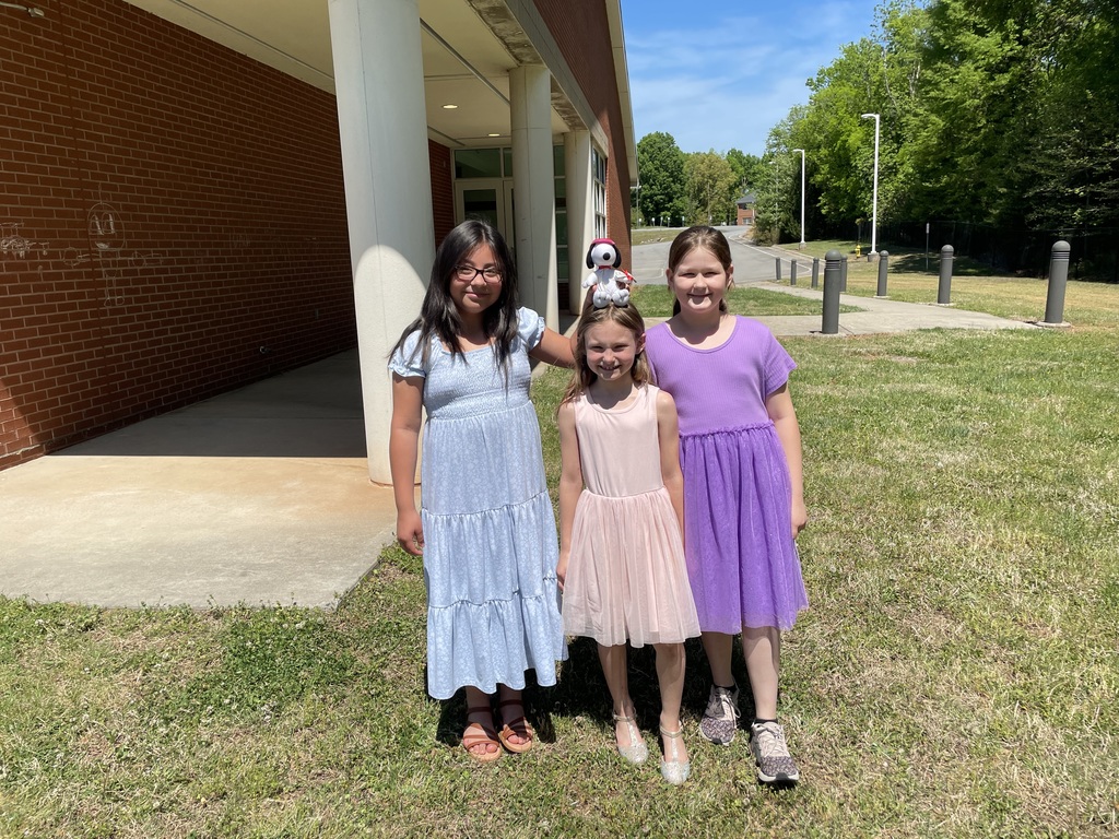3rd graders playing at recess in matching dresses.