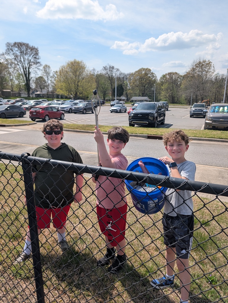 Fourth Graders cleaning up trash around campus.