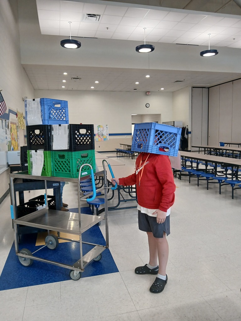 A 5th grader helping with bringing breakfast crates back to the cafeteria.