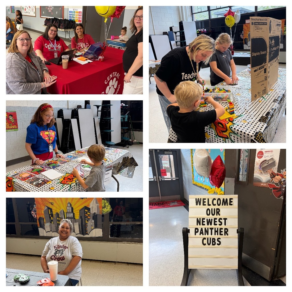 School staff welcome families at registration tables decorated with balloons and school materials. Children participate in hands-on activities at themed stations with colorful tablecloths. A staff member wearing a superhero shirt helps a child complete an activity. Another staff member smiles while seated at a table in front of a superhero city backdrop. A sign on an easel reads, “Welcome Our Newest Panther Cubs,” displayed near the school entrance.