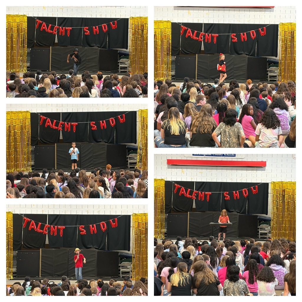 Students perform a variety of acts during a school talent show in the gym. A red “Talent Show” balloon banner hangs against a black backdrop with gold streamers on each side.