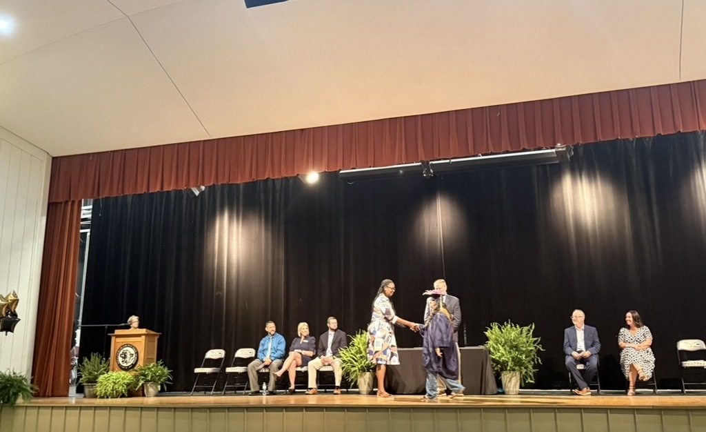 Reidsville Senior High School graduate receives diploma from Assistant Prinicpal Bozeman-Bigelow.