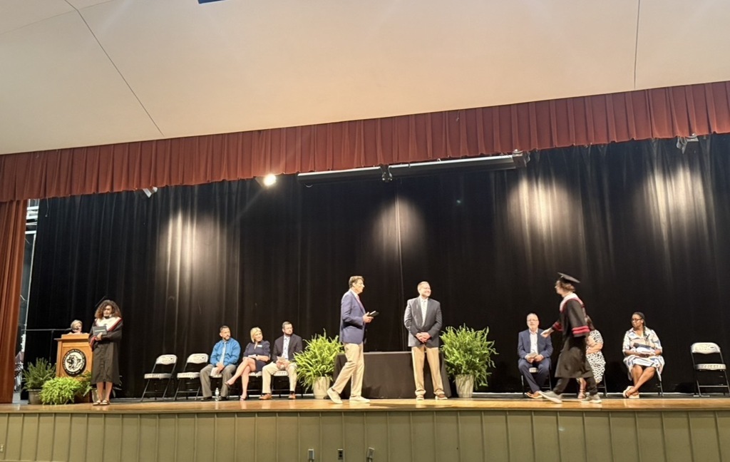 J. M. Morehead High School graduates receive diploma from Principal Tuggle.
