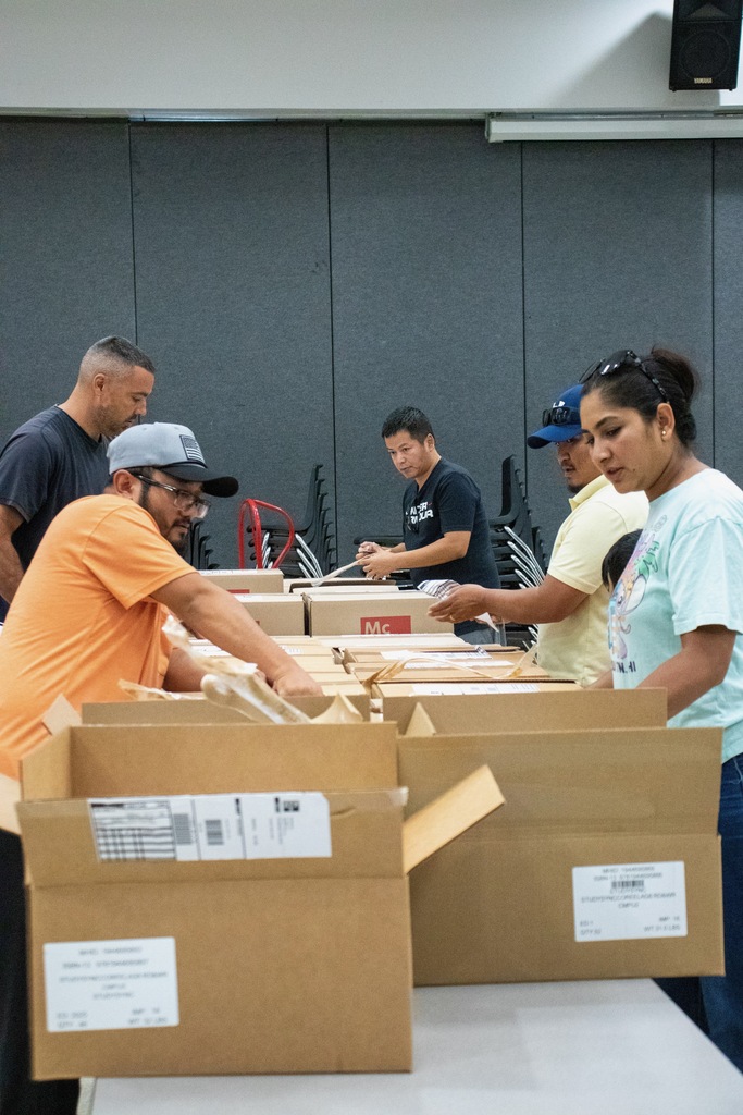 volunteers removing materials from boxes