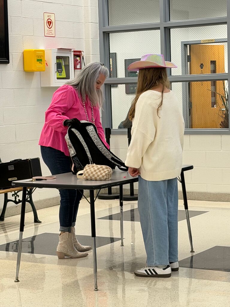 students and teachers in the hallway dressed in western wear
