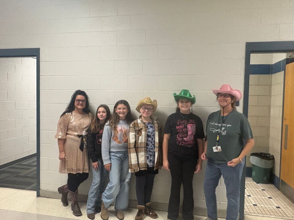 students and teachers in the hallway dressed in western wear