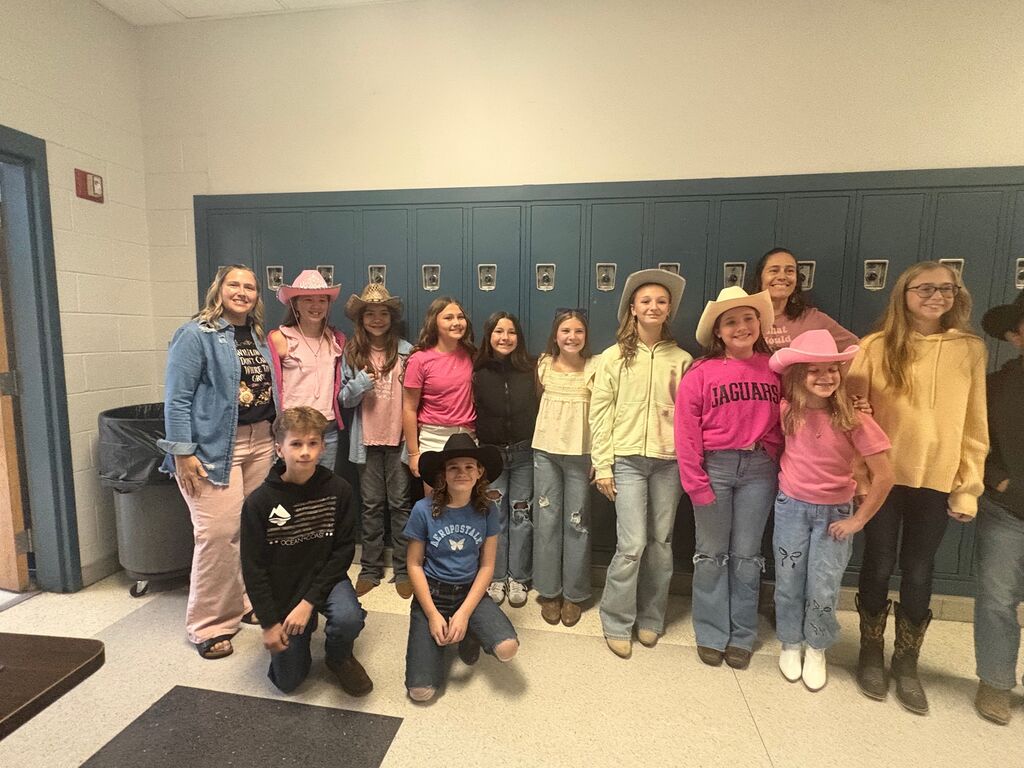 students and teachers in the hallway dressed in western wear
