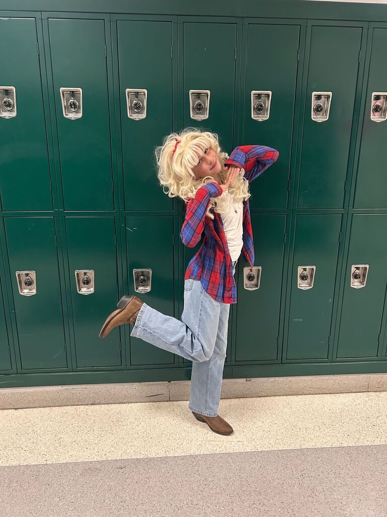 student dressed as Dolly Parton with a blonde wig