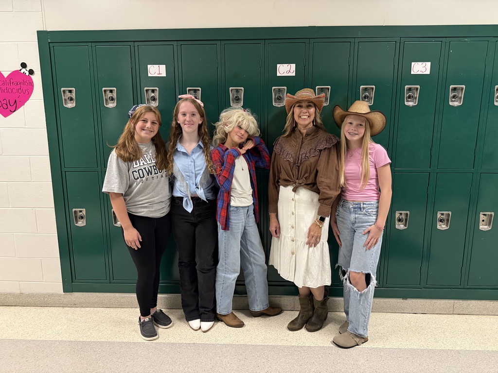 students and teachers in the hallway dressed in western wear