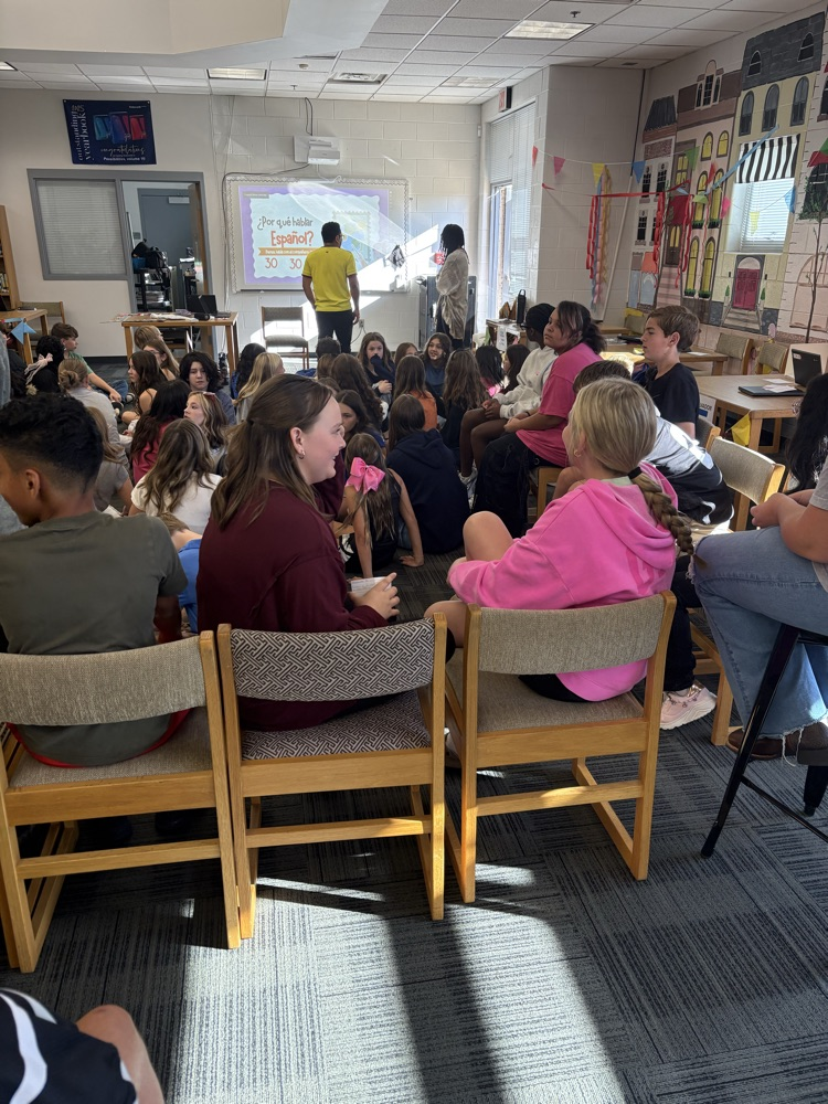 Conexiones students gathered in the media center