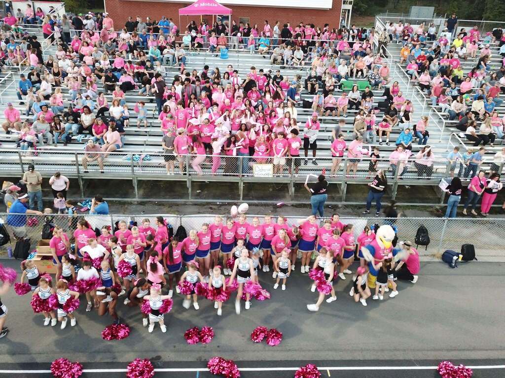T-Mobile night at McMichael High School- High school cheerleaders and little cheerleaders wearing pink with the crowd in the bleachers also decked out in pink to celebrate