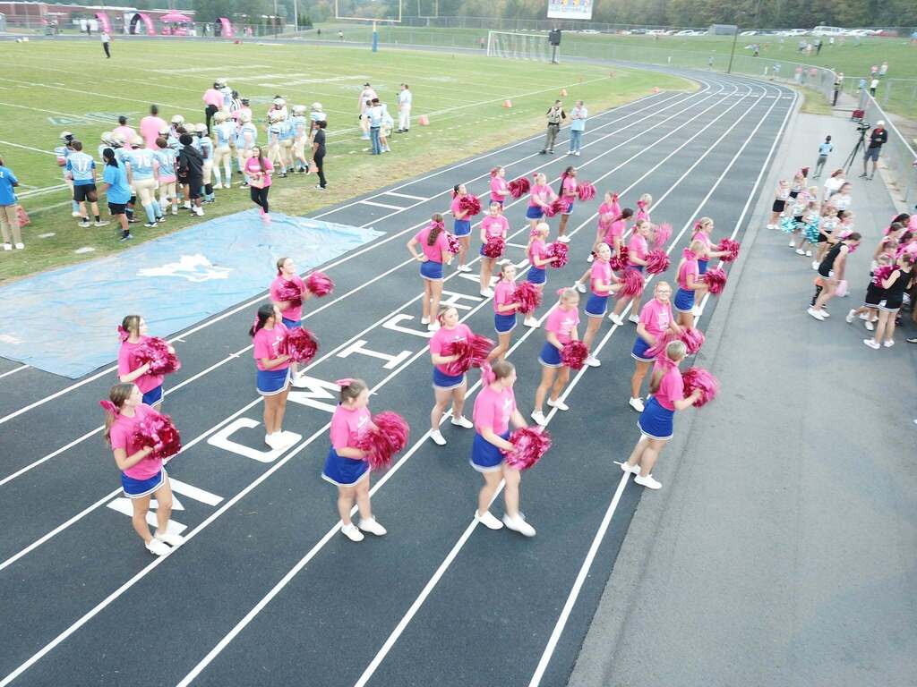 T-Mobile night at McMichael High School. Cheerleaders dressed in pink shirts with pink pom poms to celebrate