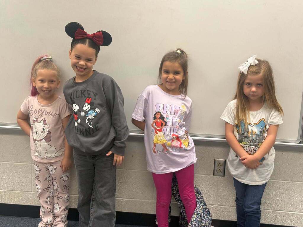 Red Ribbon Week! Lincoln Elementary School- Four little girls. Left is wearing pink "Aristocats" outfit, middle left is wearing a gray Mickey and Minnie sweat suit and Disney ears, middle right is wearing a pink "Moana" outfit, right is wearing a white Disney shirt