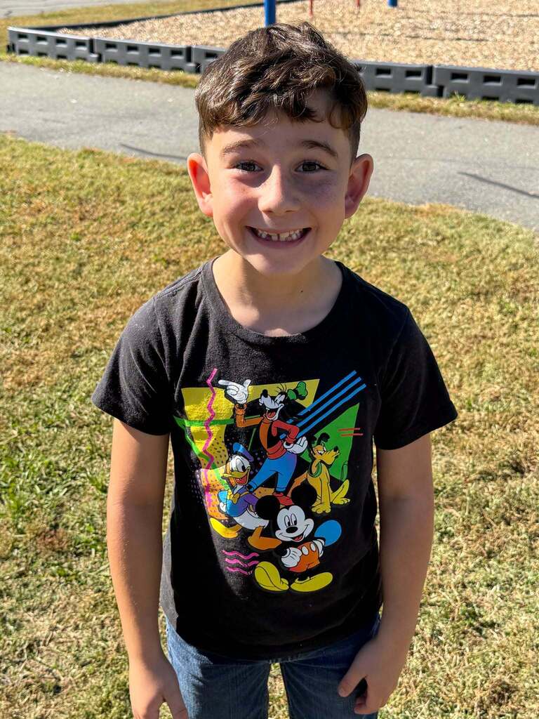 Red Ribbon Week! Lincoln Elementary School- Little boy is wearing a dark gray shirt with Mickey, Donald Duck, Goofy and Pluto on it