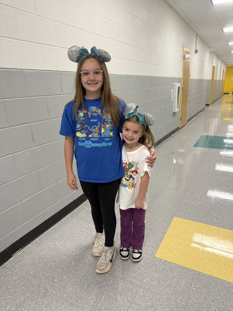 Red Ribbon Week! Lincoln Elementary School- Two little girls wearing blue, sparkly Disney ears. The older girl is in a dark blue Disney World shirt with Stitch on it and the younger girl is in a white shirt with different characters on it.
