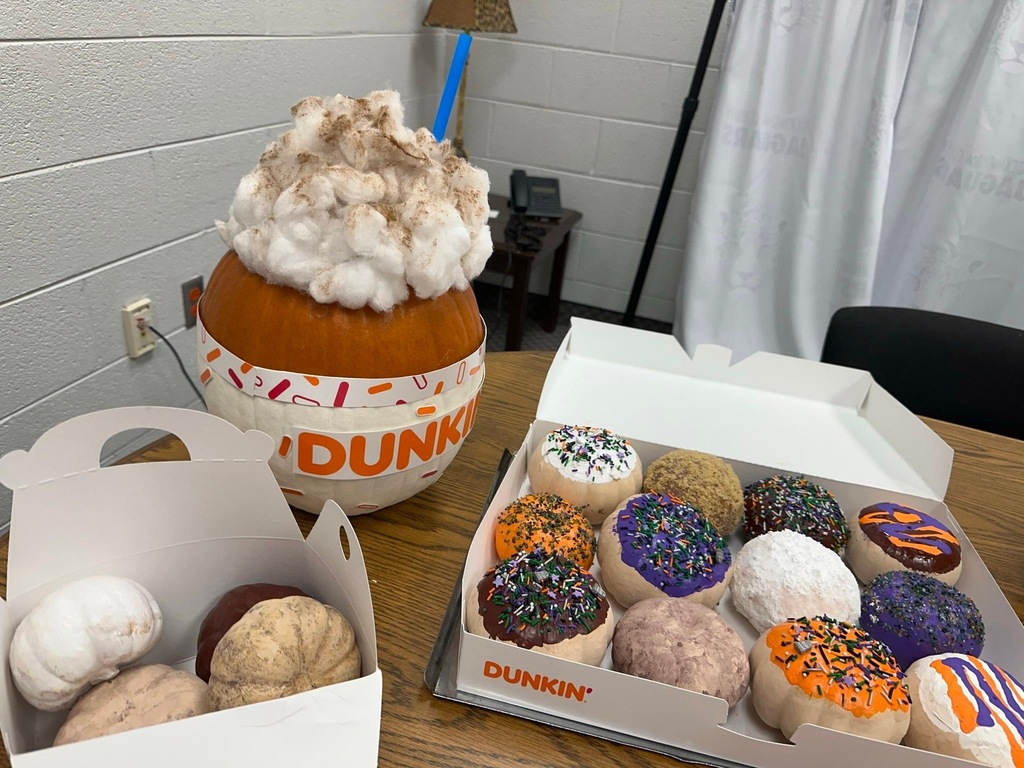 Rockingham County Middle pumpkin- A big pumpkin made to look like a pumpkin spice latte from Dunkin' Donuts, and mini pumpkins inside a Dunkin' donut box painted as different flavors, and more tiny pumpkins in a Dunkin' minis box made to look like different flavors
