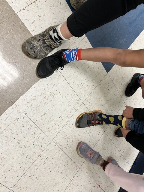 Red Ribbon Week- Monroeton Elementary crazy sock day: left to right- a student in cow-patterned socks, student in blue and red Pepsi socks, student in calf-high black socks with green avocados on them