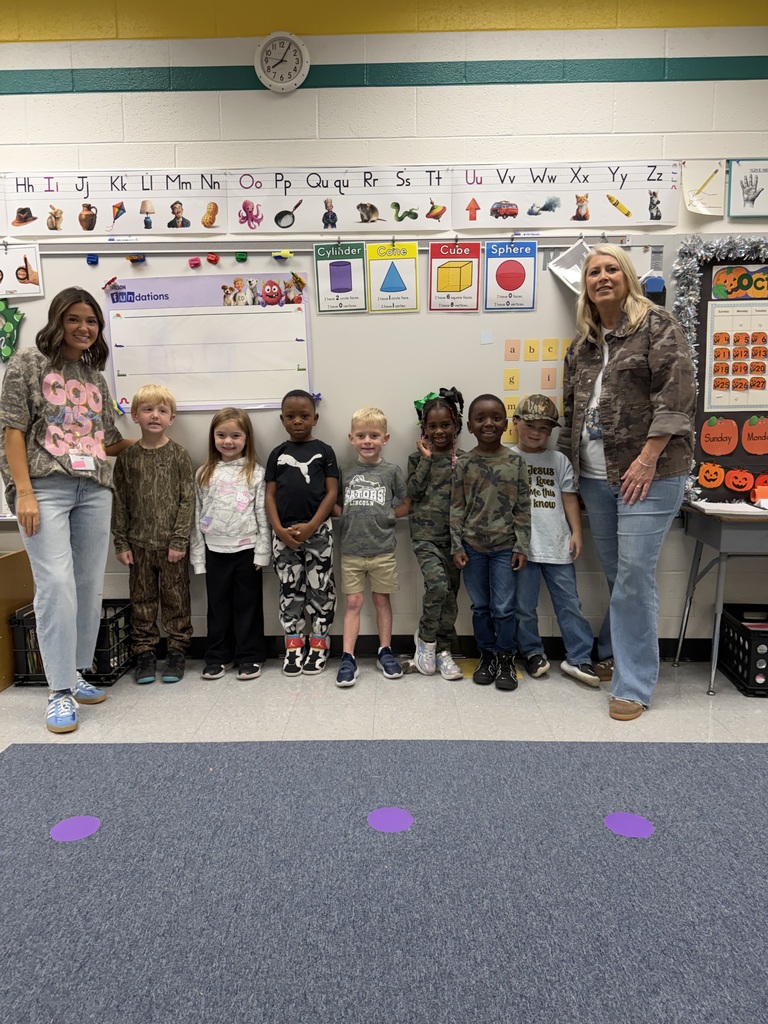 Red Ribbon Week- Lincoln Elementary Camo Day: A teacher on each end and seven students (2 girls, 5 boys) in the middle. Everyone is dressed in some form of camo