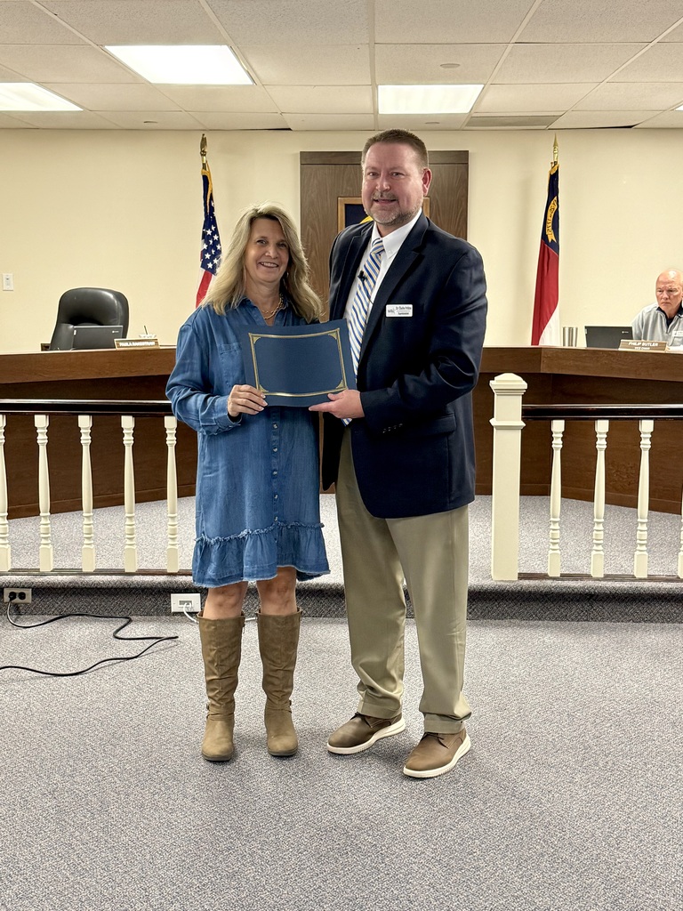 Paula Rakestraw (left) stands next to Dr. Charles Perkins (right) while being recognized for receiving the Long Leaf Pine Award