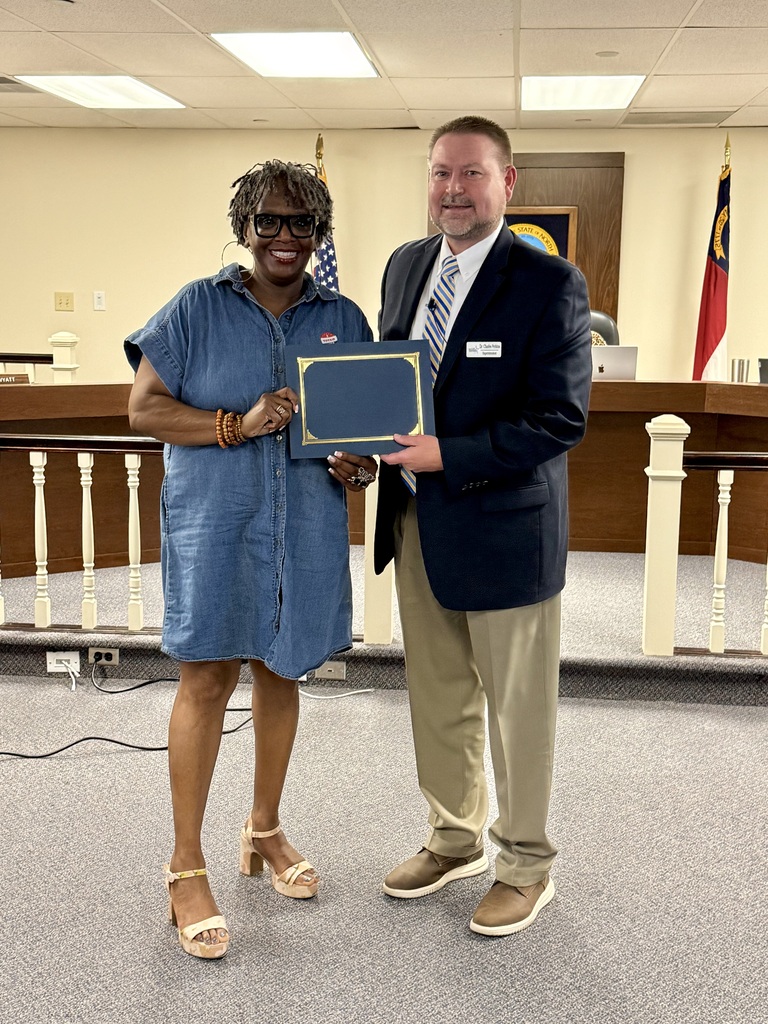 Valencia Abbott (left) stands next to Dr. Charles Perkins (right) while being recognized for receiving the Long Leaf Pine Award