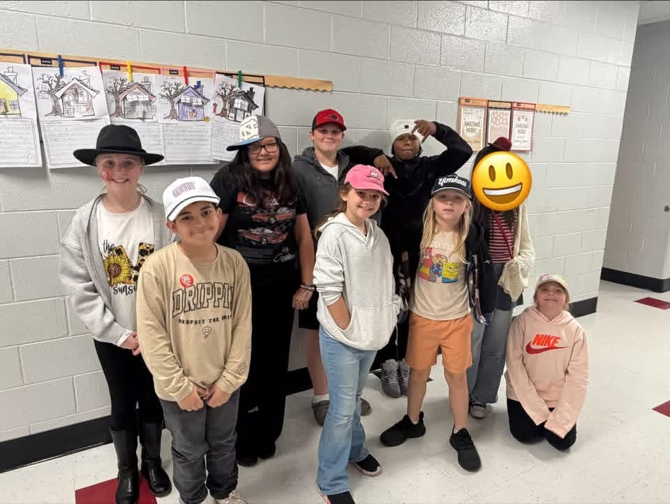 Red Ribbon Week- Central Elementary Hat Day: 9 students posed in a group picture in the hallway, all wearing different style hats