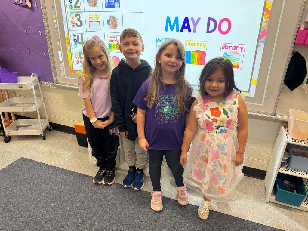 Red Ribbon Week- Lincoln Elementary Dress like a student/teacher day: four students (1 boy, 3 girls) dressed as teachers and posing in the classroom
