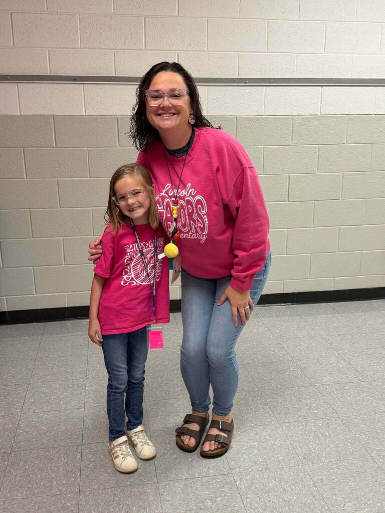 Red Ribbon Week- Lincoln Elementary Dress like a student/teacher day: a female student and teacher dressed alike posing together in the hallway